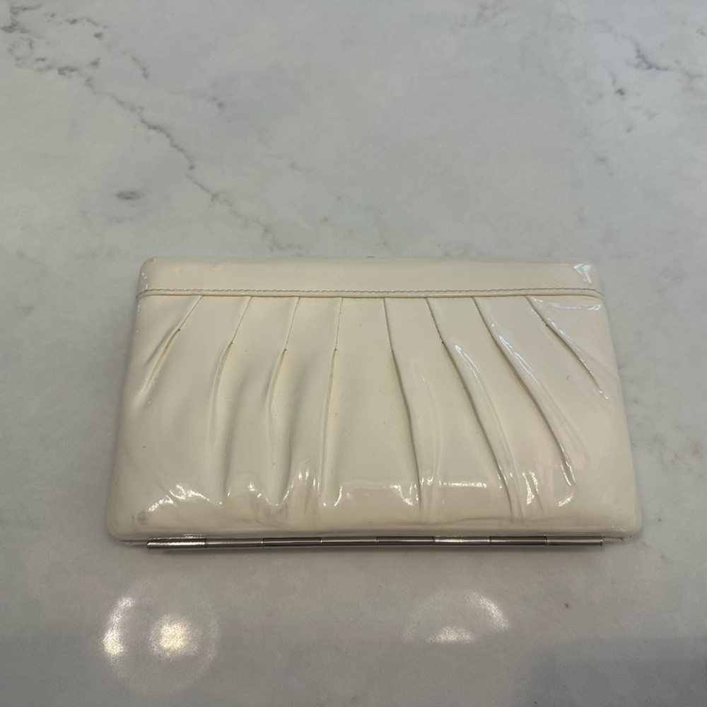 White patent leather like clasp wallet